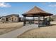 Community gazebo is situated on a large manicured lawn and features a paved walkway at 16022 W 63Rd Ln # A, Arvada, CO 80403