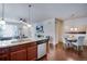 Open kitchen and dining area with hardwood floors and lots of natural light at 16022 W 63Rd Ln # A, Arvada, CO 80403