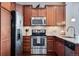 Modern kitchen features stainless steel appliances and hardwood cabinets at 16022 W 63Rd Ln # A, Arvada, CO 80403