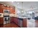 Modern kitchen with stainless steel appliances, granite countertops, and an open floor plan at 16022 W 63Rd Ln # A, Arvada, CO 80403