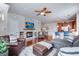 Cozy living room features a stone fireplace, hardwood floors, and comfortable seating arrangements at 16022 W 63Rd Ln # A, Arvada, CO 80403