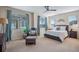 Comfortable primary suite with a ceiling fan, chair, and lots of natural light from several windows at 16022 W 63Rd Ln # A, Arvada, CO 80403