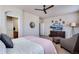 Comfortable primary suite with a ceiling fan, chair, and lots of natural light from several windows at 16022 W 63Rd Ln # A, Arvada, CO 80403
