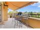 Balcony view of the landscaped property with a table, chairs, and shaded awning at 2500 E Cherry Creek South Dr # 306, Denver, CO 80209