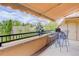 Balcony provides a scenic view with a table, chairs, and shaded awning at 2500 E Cherry Creek South Dr # 306, Denver, CO 80209