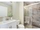 This bathroom features a marble tiled shower, white vanity, and decorative silver-framed mirror at 2500 E Cherry Creek South Dr # 306, Denver, CO 80209
