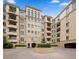 View of the neutral building exterior with well-kept landscaping and fountain at 2500 E Cherry Creek South Dr # 306, Denver, CO 80209