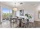 View of dining area with hardwood floors, artwork, and sliding glass doors to balcony at 2500 E Cherry Creek South Dr # 306, Denver, CO 80209