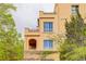 Elegant building featuring balconies and arched windows, surrounded by lush greenery at 2500 E Cherry Creek South Dr # 306, Denver, CO 80209