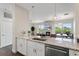 Open concept kitchen with bar seating, granite countertops, and an adjacent living area with a fireplace at 2500 E Cherry Creek South Dr # 306, Denver, CO 80209