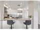 Close-up of kitchen bar with pendant lights, stone countertops and stainless steel appliances at 2500 E Cherry Creek South Dr # 306, Denver, CO 80209