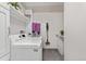 Bright laundry room featuring a washer, dryer, shelving, and storage space at 2500 E Cherry Creek South Dr # 306, Denver, CO 80209