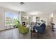 Wide view of living and dining area with fireplace, hardwood floors, large windows, and seating at 2500 E Cherry Creek South Dr # 306, Denver, CO 80209