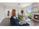 View of living room with hardwood floors, stone fireplace, large window, and seating at 2500 E Cherry Creek South Dr # 306, Denver, CO 80209