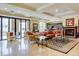 Elegant lounge area featuring a cozy fireplace, stylish furniture, and a well-stocked bookshelf at 2500 E Cherry Creek South Dr # 306, Denver, CO 80209