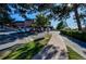 Golf course bag drop area featuring golf carts and brick building with mature landscaping at 2479 S Xanadu Way # C, Aurora, CO 80014