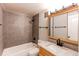 Bathroom with tiled shower, modern fixtures and wood vanity at 2479 S Xanadu Way # C, Aurora, CO 80014