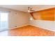 Bedroom featuring wood floors, wood paneled wall, and a ceiling fan at 2479 S Xanadu Way # C, Aurora, CO 80014