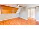 Bedroom featuring wood floors, wood paneled wall, and a mirrored closet at 2479 S Xanadu Way # C, Aurora, CO 80014