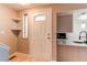 Inviting entryway featuring a white front door with glass panel and tile flooring at 2479 S Xanadu Way # C, Aurora, CO 80014