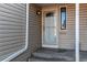 Front door with glass accent and welcome mat sits below a small awning at the front entrance at 2479 S Xanadu Way # C, Aurora, CO 80014