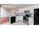View of the updated kitchen with eat-in breakfast bar and stainless steel oven at 2479 S Xanadu Way # C, Aurora, CO 80014