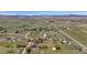 Expansive aerial view of a property showing a home, large yard, and surrounding landscape with mountain backdrop at 1720 Chaparro Cir, Berthoud, CO 80513