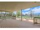 Expansive deck overlooking a beautifully landscaped backyard with lush greenery and a charming fire pit at 1720 Chaparro Cir, Berthoud, CO 80513