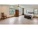 Spacious bedroom featuring hard floors, a ceiling fan, bright windows, and a fireplace at 1720 Chaparro Cir, Berthoud, CO 80513