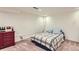 Cozy bedroom featuring a white brick wall, neutral carpet and a comfortable bed with stylish bedding at 1720 Chaparro Cir, Berthoud, CO 80513