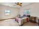 Cozy bedroom with two windows, a comfortable bed, and a bedside table at 1720 Chaparro Cir, Berthoud, CO 80513