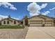 Charming single-story home with manicured lawn and attached three-car garage, with stucco siding at 1720 Chaparro Cir, Berthoud, CO 80513