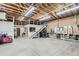 Spacious garage with exposed wood beams, a storage loft, and ample room for vehicles at 1720 Chaparro Cir, Berthoud, CO 80513