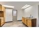 Kitchenette with wooden cabinets, stainless steel sink and a door to the outside at 1720 Chaparro Cir, Berthoud, CO 80513