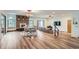 Open-concept living area with hardwood floors, a fireplace, large windows, and access to the outdoors at 1720 Chaparro Cir, Berthoud, CO 80513