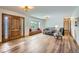 Bright living room with hardwood floors, large windows, a comfortable seating area, and decorative wood door at 1720 Chaparro Cir, Berthoud, CO 80513