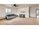 Bright living room featuring a ceiling fan and a large window for natural light at 1720 Chaparro Cir, Berthoud, CO 80513
