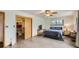 Comfortable main bedroom with closet, a ceiling fan, and two bright windows overlooking the backyard at 1720 Chaparro Cir, Berthoud, CO 80513