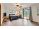 Bright main bedroom with sliding doors leading to a private balcony and large windows at 1720 Chaparro Cir, Berthoud, CO 80513