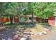 Backyard with a brick house, deck, mature trees, and a quaint rock border adding natural charm at 760 S 42Nd St, Boulder, CO 80305