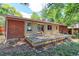 Charming backyard with spacious deck, brick accents, sliding glass doors, and mature trees at 760 S 42Nd St, Boulder, CO 80305