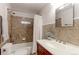 Bathroom featuring decorative tile, white vanity and toilet, and shower with updated fixtures at 760 S 42Nd St, Boulder, CO 80305