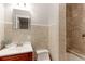 Bathroom featuring a wood vanity, modern fixtures, and tiled walls, creating a stylish and functional space at 760 S 42Nd St, Boulder, CO 80305