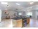 Bright kitchen boasts an island with stainless steel oven, hardwood floors, and seamlessly connects dining and living areas at 760 S 42Nd St, Boulder, CO 80305