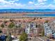 Scenic aerial view of a community with a Denver skyline and snow-capped mountains at 14086 E Stanford Cir # F09, Aurora, CO 80015