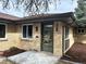 Charming brick home with modern front door, nicely landscaped with fresh mulch, and new gutters at 2812 N Harrison St, Denver, CO 80205