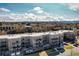 Elevated view of a multi-Gathering residence with balcony views of the city and mountains at 6000 W Floyd Ave # 307, Denver, CO 80227