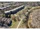 Aerial view of a modern apartment complex adjacent to a walking path and stream at 6000 W Floyd Ave # 307, Denver, CO 80227