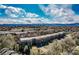 Aerial view of condo community with mature trees, blue skies and scenic mountain views at 6000 W Floyd Ave # 307, Denver, CO 80227