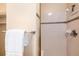 Neutral bathroom with tile shower, updated fixtures, and a soft white towel on the towel bar at 6000 W Floyd Ave # 307, Denver, CO 80227